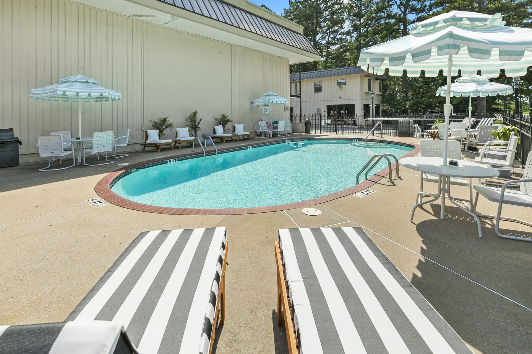 Striped loungers at the edge of the pool